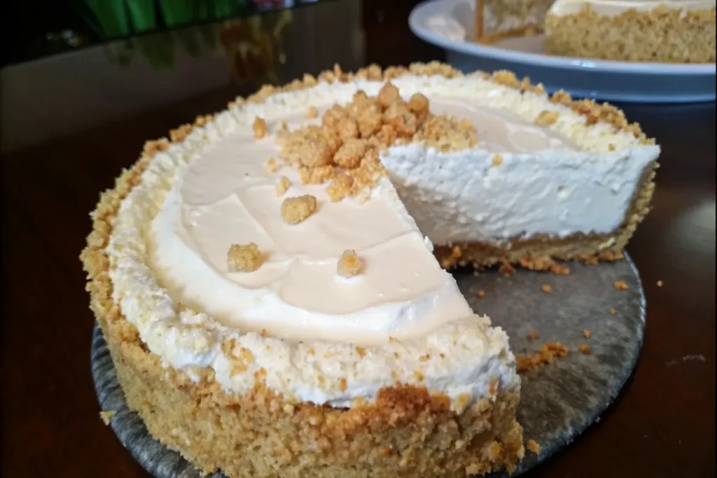 Sliced no-bake cheesecake Rice Krispy treats on a neutral backdrop.